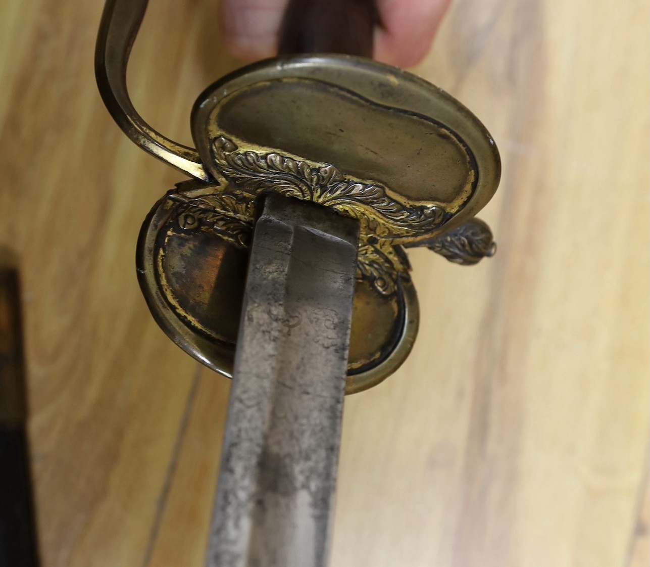 An 18th century European brass hilted sword and scabbard. 89cm long